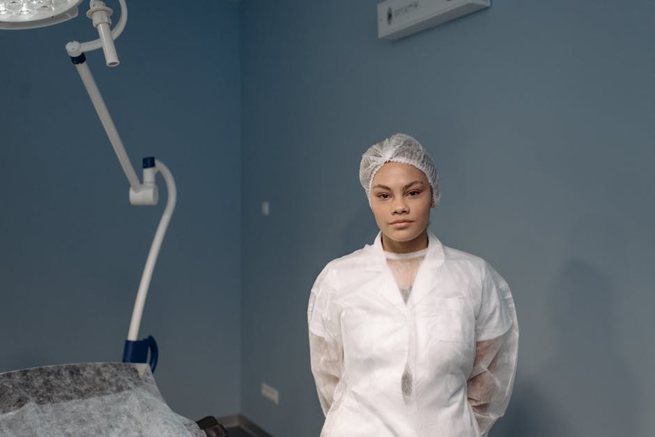 A young female medical professional posing confidently in a clinic room